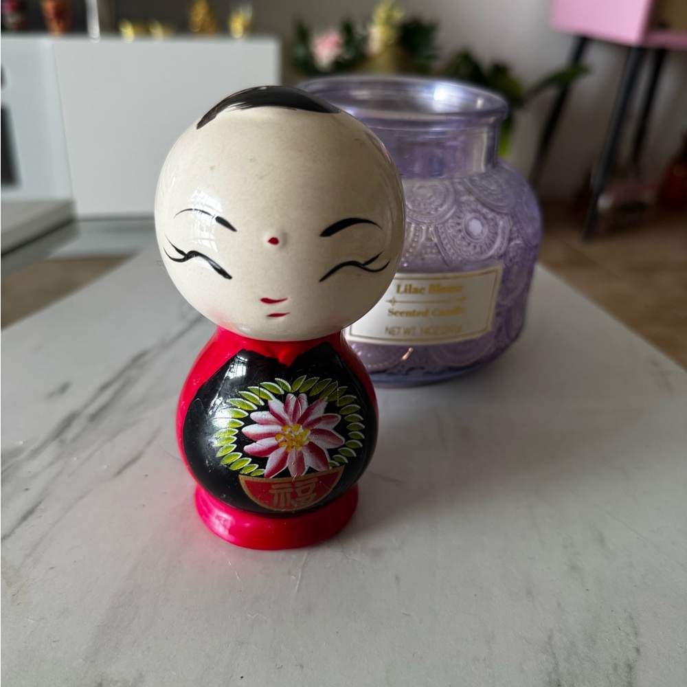 Colorful Doll Figurine with Floral Design coin collector